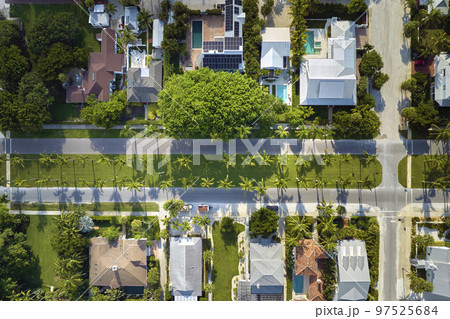 View from above of large residential houses in closed living golf club in south Florida. American dream homes as example of real estate development in US suburbs View from above of large residential houses in closed living golf club in south Florida. American dream homes as example of real estate development in US suburbs 97525684