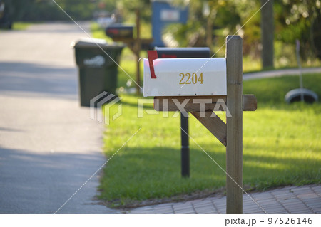 Typical american outdoors mail box on suburban street side Typical american outdoors mail box on suburban street side 97526146
