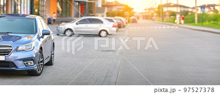 Front view of new car parked on city street side. 97527378