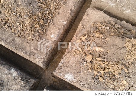 Dug out trench for building works of new house concrete foundation on construction site Dug out trench for building works of new house concrete foundation on construction site 97527785