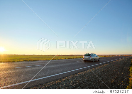 Car driving fast on intercity road at sunset. Highway traffic in evening Car driving fast on intercity road at sunset. Highway traffic in evening 97528217