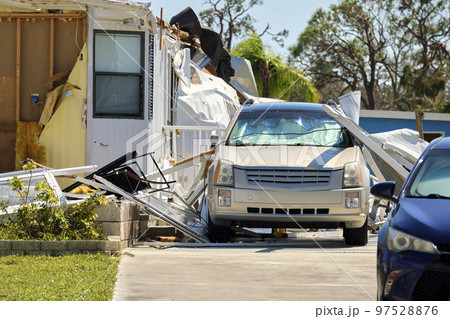 Badly damaged mobile homes after hurricane Ian in Florida residential area. Consequences of natural disaster Badly damaged mobile homes after hurricane Ian in Florida residential area. Consequences of natural disaster 97528876
