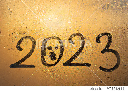 numbers 2023 of new year with kissing smile face paint on splashed by rain foggy glass on blue sunset window numbers 2023 of new year with kissing smile face paint on splashed by rain foggy glass on blue sunset window 97528911