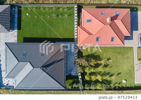 Aerial view of residential house with backyard in suburban rural area 97529413