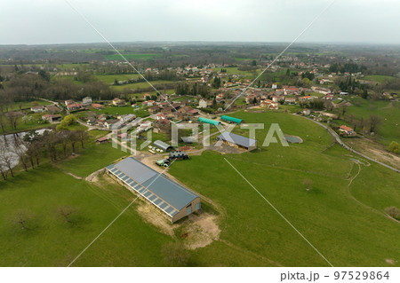 Aerial view of farm building with photovoltaic solar panels mounted on rooftop for producing clean ecological electricity. Production of renewable energy concept 97529864
