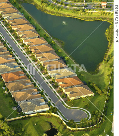 Aerial view of cul de sac at neighbourhood road dead end with densely built homes in Florida closed living area. Real estate development of family houses and infrastructure in american suburbs Aerial view of cul de sac at neighbourhood road dead end with densely built homes in Florida closed living area. Real estate development of family houses and infrastructure in american suburbs 97529963