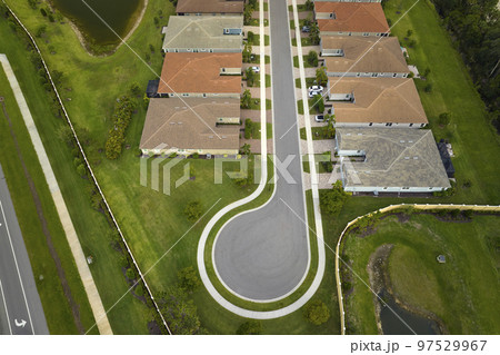 Aerial view of cul de sac at neighbourhood road dead end with densely built homes in Florida closed living area. Real estate development of family houses and infrastructure in american suburbs 97529967