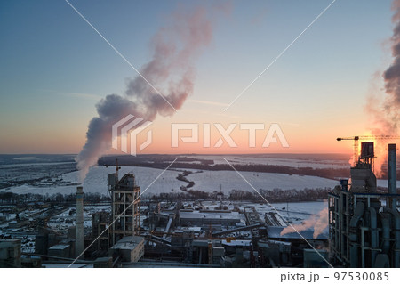 Aerial view of cement factory tower with high concrete plant structure at industrial production area at sunset. Manufacturing and global industry concept 97530085