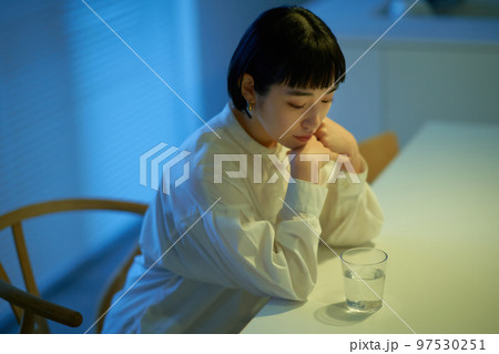 部屋でぐったりとする女性 97530251