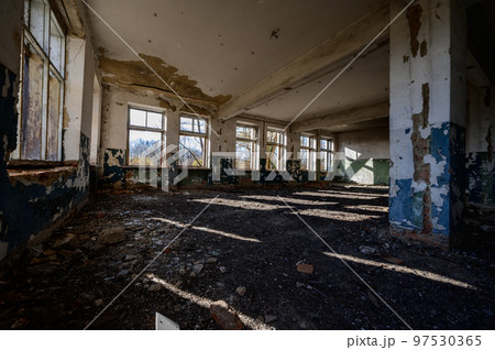 An abandoned warehouse that has been destroyed by people and time. 97530365