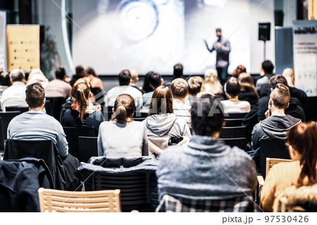 Speaker giving a talk in conference hall at business event. Audience at the conference hall. Business and Entrepreneurship concept. Focus on unrecognizable people in audience. Speaker giving a talk in conference hall at business event. Audience at the conference hall. Business and Entrepreneurship concept. Focus on unrecognizable people in audience. 97530426