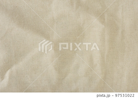 Texture of linen fabric in natural yellow color. The surface of the linen fabric as a background or banner, close-up. 97531022