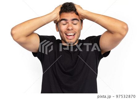 Amazed young man with hands on head Amazed young man with hands on head 97532870