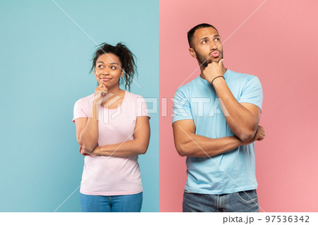 Portrait of thoughtful black man and woman thinking and looking away, touching chin, dreaming or making decision Portrait of thoughtful black man and woman thinking and looking away, touching chin, dreaming or making decision 97536342