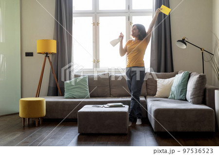 Happy Young Arab Woman Having Fun While Cleaning At Home 97536523
