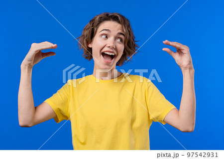 Funny woman showing bla-bla-bla gesture with hands on blue background. Empty promises, irony, blah Funny woman showing bla-bla-bla gesture with hands on blue background. Empty promises, irony, blah 97542931