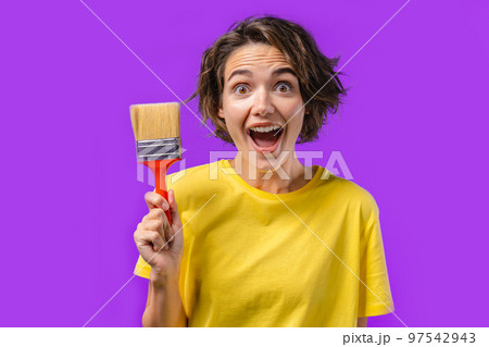 Happy woman artist with painting brush on violet background. Creative person, fantasy, idea, non 97542943