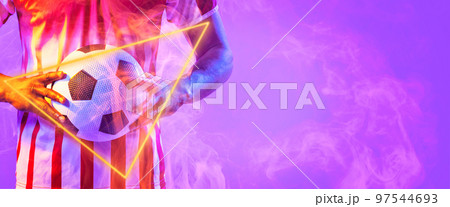 Midsection of biracial male player holding soccer ball with illuminated triangle shape, copy space 97544693