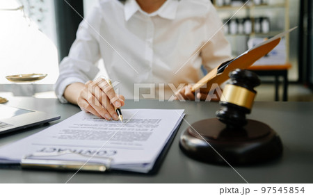 justice and law concept.Male judge in a courtroom the gavel, working with smart phone and laptop and digital tablet computer on table justice and law concept.Male judge in a courtroom the gavel, working with smart phone and laptop and digital tablet computer on table 97545854