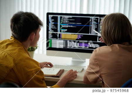 Friends learning coding together, view from the back 97545968