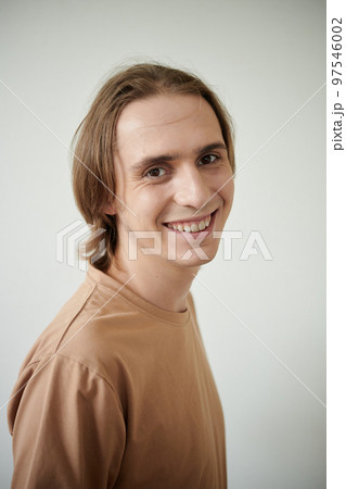 Portrait of positive young man smiling at camera Portrait of positive young man smiling at camera 97546002