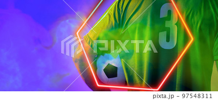 Rear view of caucasian male player in 3 number jersey holding ball by illuminated hexagon 97548311