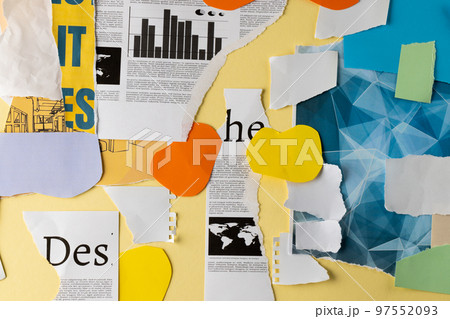 Ripped up pieces of notebooks, newspaper and coloured paper arranged on yellow background 97552093