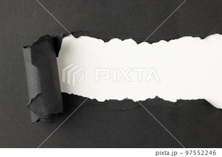 Ripped up piece of black paper with copy space on white background 97552246