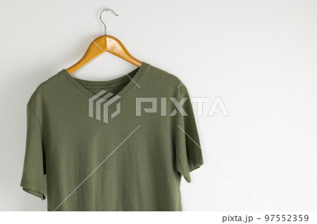 Tshirt hanging on coat hanger and copy space on white background Tshirt hanging on coat hanger and copy space on white background 97552359