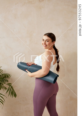 Smiling Woman Relaxing After Yoga. Overweight Female Posing After Yoga Session Smiling Woman Relaxing After Yoga. Overweight Female Posing After Yoga Session 97553245