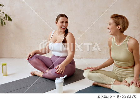 Smiling Woman Talking After Yoga. Female Friends Talking After Yoga Session 97553270