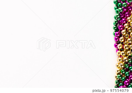 Composition of colourful mardi gras beads with copy space on white background with copy space 97554079