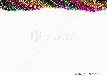Composition of colourful mardi gras beads with copy space on white background with copy space 97554082