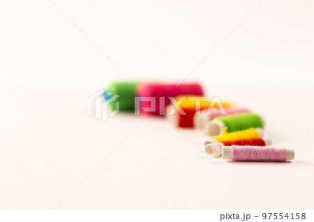 Composition of colourful sewing crewels on white background with copy space Composition of colourful sewing crewels on white background with copy space 97554158