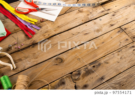 Composition of sewing equipment on wooden background with copy space Composition of sewing equipment on wooden background with copy space 97554171