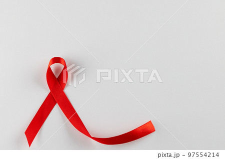 Composition of red ribbon for hiv or aids awareness, on white background with copy space Composition of red ribbon for hiv or aids awareness, on white background with copy space 97554214