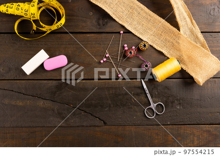 Composition of sewing equipment on wooden background with copy space Composition of sewing equipment on wooden background with copy space 97554215