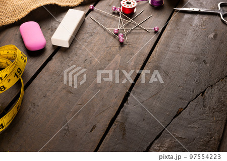 Composition of sewing equipment on wooden background with copy space 97554223