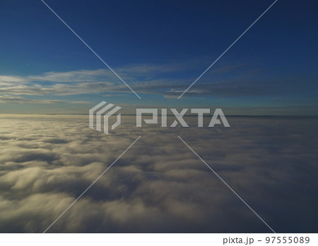 flight above clouds through the cloudy sky 97555089