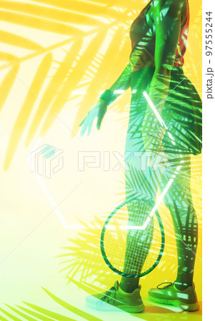 Composite of young african american female tennis player with neon and leaf pattern 97555244