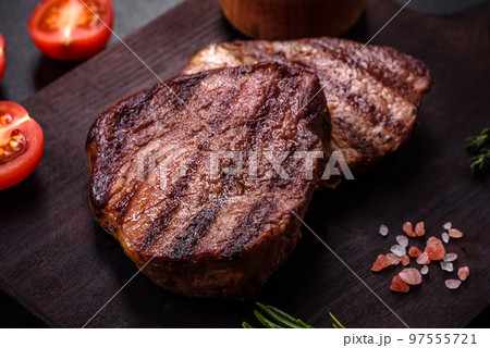 Delicious fresh juicy beef steak with spices and herbs 97555721