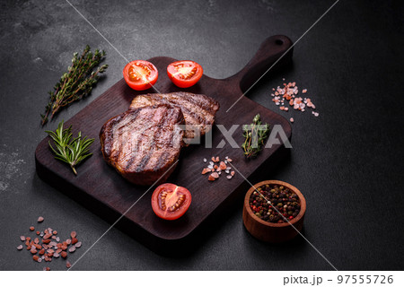 Delicious fresh juicy beef steak with spices and herbs Delicious fresh juicy beef steak with spices and herbs 97555726