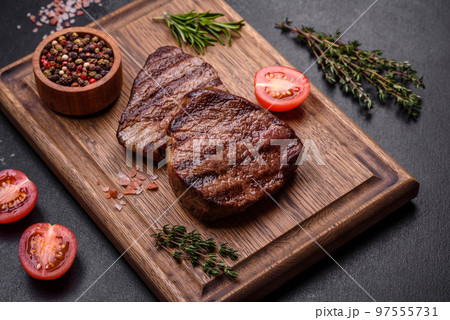 Delicious fresh juicy beef steak with spices and herbs Delicious fresh juicy beef steak with spices and herbs 97555731