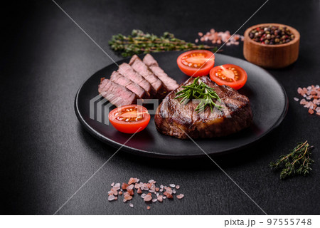Delicious fresh juicy beef steak with spices and herbs Delicious fresh juicy beef steak with spices and herbs 97555748