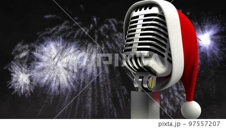 Image of santa hat on retro microphone with white christmas and new year fireworks in night sky 97557207