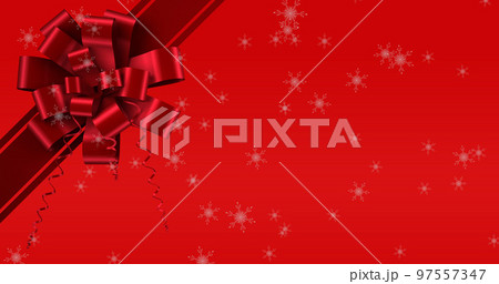 Image of snow falling over ribbon on red background 97557347