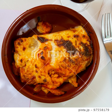 Top view of traditional italian meat lasagna with grated cheese served in clay plate Top view of traditional italian meat lasagna with grated cheese served in clay plate 97558179