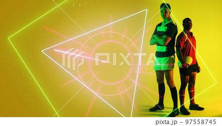 Composite of diverse male rugby players standing by illuminated geometric shape on yellow background Composite of diverse male rugby players standing by illuminated geometric shape on yellow background 97558745
