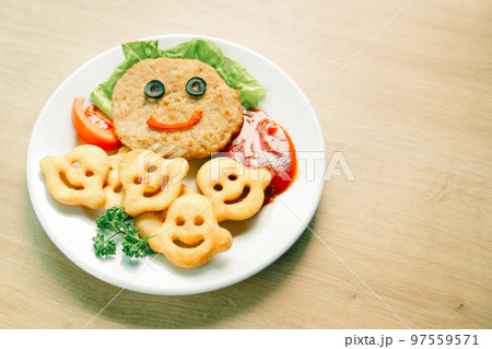 schnitzel and garnish on a dish in a children's restaurant 97559571