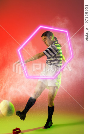 Illuminated hexagon over caucasian female rugby player kicking ball amidst smoke, copy space Illuminated hexagon over caucasian female rugby player kicking ball amidst smoke, copy space 97559951